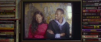 Movie still from “Climax” (2018), directed by Gaspar Noé – A couple of people sitting next to each other on top of a tv screen; Close Up shot, Over the shoulder angle