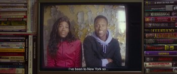 Movie still from “Climax” (2018), directed by Gaspar Noé – Two young people sitting on a tv screen; Medium shot, High angle