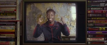 Movie still from “Climax” (2018), directed by Gaspar Noé – A young man in a black and red jacket is posing for a picture; Medium shot, High angle