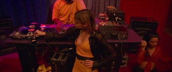 Movie still from “Climax” (2018), directed by Gaspar Noé – A woman standing next to a man in a yellow dress; Medium shot, High angle