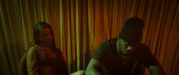 Movie still from “Climax” (2018), directed by Gaspar Noé – A man and a woman sitting in a room; Medium shot, Low angle