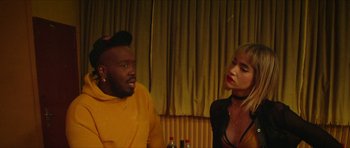 Movie still from “Climax” (2018), directed by Gaspar Noé – A man and a woman sitting next to each other in a room; Close Up shot, Over the shoulder angle