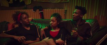 Movie still from “Climax” (2018), directed by Gaspar Noé – A couple of people sitting on top of a brown couch; Medium shot, Over the shoulder angle