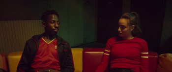 Movie still from “Climax” (2018), directed by Gaspar Noé – A man and a woman sitting next to each other on a bench; Medium shot, Over the shoulder angle