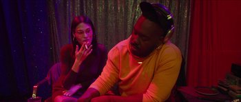 Movie still from “Climax” (2018), directed by Gaspar Noé – A man and a woman sitting next to each other in a room; Medium shot, Low angle