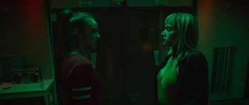 Movie still from “Climax” (2018), directed by Gaspar Noé – Two women standing next to each other in front of lockers; Medium shot, Low angle