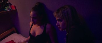 Movie still from “Climax” (2018), directed by Gaspar Noé – Two young women standing next to each other in a dark room; Close Up shot, Low angle