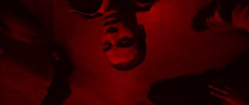 Movie still from “Climax” (2018), directed by Gaspar Noé – A man's face is reflected in a mirror; Extreme Close Up shot, Overhead angle