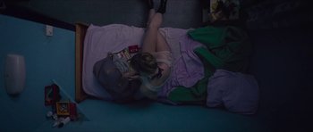 Movie still from “Climax” (2018), directed by Gaspar Noé – A woman laying on the floor with her head on a pillow; Wide shot, Overhead angle