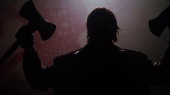Movie still from “Cobra” (1986), directed by George P. Cosmatos – A person with a hair dryer in a dark room; Close Up shot, Low angle
