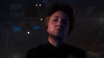 Movie still from “Cobra” (1986), directed by George P. Cosmatos – A woman in a black shirt is looking up; Close Up shot, Low angle