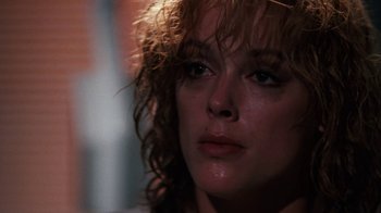 Movie still from “Cobra” (1986), directed by George P. Cosmatos – A woman's eyes and face; Close Up shot, Over the shoulder angle