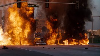 Movie still from “Cobra” (1986), directed by George P. Cosmatos – A street sign that is on the side of the road; Extreme Wide shot, High angle