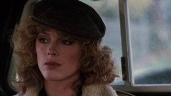 Movie still from “Cobra” (1986), directed by George P. Cosmatos – A person wearing a hat; Close Up shot, Over the shoulder angle