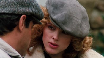Movie still from “Cobra” (1986), directed by George P. Cosmatos – A man and a woman wearing a hat; Close Up shot, Over the shoulder angle