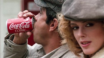 Movie still from “Cobra” (1986), directed by George P. Cosmatos – A man and a woman are drinking soda; Close Up shot, Over the shoulder angle