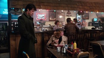 Movie still from “Cobra” (1986), directed by George P. Cosmatos – A woman sitting at a table in front of a man; Wide shot, Over the shoulder angle