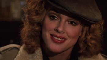 Movie still from “Cobra” (1986), directed by George P. Cosmatos – A person wearing a hat; Close Up shot, Over the shoulder angle