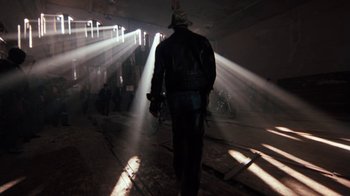 Movie still from “Cobra” (1986), directed by George P. Cosmatos – A man in a leather jacket walking through a tunnel; Wide shot, Low angle