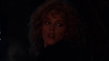 Movie still from “Cobra” (1986), directed by George P. Cosmatos – A person with curly hair; Close Up shot, Low angle