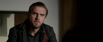 Movie still from “Colossal” (2016), directed by Nacho Vigalondo – A person wearing a jacket; Close Up shot, Over the shoulder angle