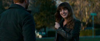Movie still from “Colossal” (2016), directed by Nacho Vigalondo – A beautiful young lady standing next to a man in a leather jacket; Close Up shot, Over the shoulder angle