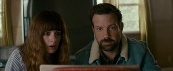 Movie still from “Colossal” (2016), directed by Nacho Vigalondo – A man and a woman are looking at a book; Close Up shot, Over the shoulder angle