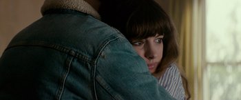 Movie still from “Colossal” (2016), directed by Nacho Vigalondo – A person hugging another person; Close Up shot, Over the shoulder angle