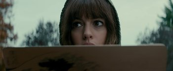 Movie still from “Colossal” (2016), directed by Nacho Vigalondo – A person looking over a wooden board; Close Up shot, Overhead angle