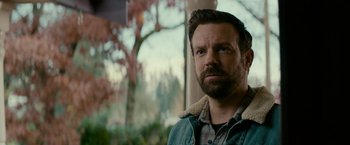 Movie still from “Colossal” (2016), directed by Nacho Vigalondo – A person wearing a jacket; Close Up shot, Over the shoulder angle