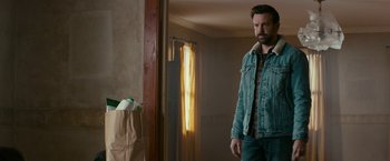 Movie still from “Colossal” (2016), directed by Nacho Vigalondo – A man standing in front of a mirror in a room; Medium shot, Over the shoulder angle