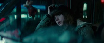 Movie still from “Colossal” (2016), directed by Nacho Vigalondo – A woman sitting in front of a window with her hand on her head; Close Up shot, Over the shoulder angle