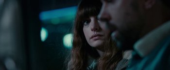 Movie still from “Colossal” (2016), directed by Nacho Vigalondo – A person with long brown hair; Close Up shot, Over the shoulder angle