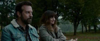 Movie still from “Colossal” (2016), directed by Nacho Vigalondo – A woman sitting next to a man on a bench; Close Up shot, Over the shoulder angle