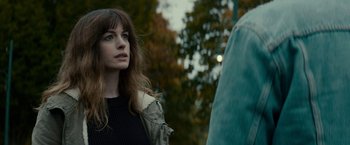 Movie still from “Colossal” (2016), directed by Nacho Vigalondo – A woman standing in front of a waterfall; Close Up shot, Over the shoulder angle