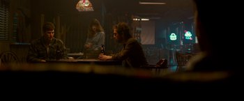 Movie still from “Colossal” (2016), directed by Nacho Vigalondo – A man and a woman are sitting at a table; Medium shot, Over the shoulder angle