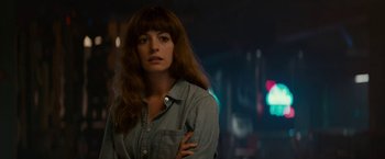 Movie still from “Colossal” (2016), directed by Nacho Vigalondo – A woman standing in front of a neon sign; Close Up shot, Over the shoulder angle