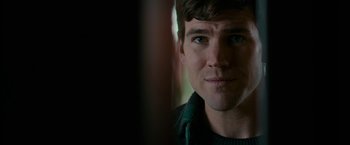 Movie still from “Colossal” (2016), directed by Nacho Vigalondo – A man's face in front of a window; Close Up shot, Over the shoulder angle