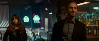 Movie still from “Colossal” (2016), directed by Nacho Vigalondo – A man sitting in a room at a restaurant; Close Up shot, Over the shoulder angle