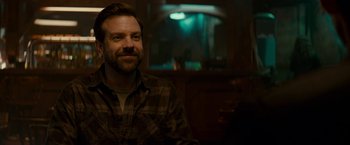 Movie still from “Colossal” (2016), directed by Nacho Vigalondo – A man sitting in front of a mirror in a room; Close Up shot, Over the shoulder angle