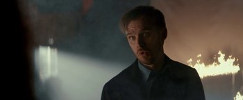 Movie still from “Colossal” (2016), directed by Nacho Vigalondo – A person wearing a suit and tie; Close Up shot, Low angle