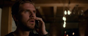 Movie still from “Colossal” (2016), directed by Nacho Vigalondo – A person talking on a cell phone; Close Up shot, Low angle