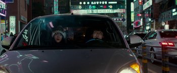 Movie still from “Colossal” (2016), directed by Nacho Vigalondo – Two young children in the back seat of a car; Medium shot, Over the shoulder angle