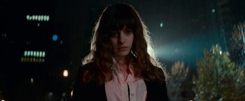 Movie still from “Colossal” (2016), directed by Nacho Vigalondo – A woman with long brown hair wearing a black jacket; Close Up shot, Low angle
