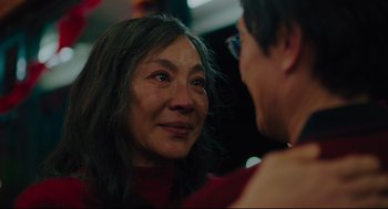 An older asian woman looking at a younger asian man