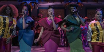 Movie still from “Coming 2 America” (2021), directed by Craig Brewer – A group of women singing on a stage; Medium shot, High angle