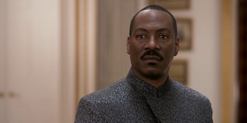 Movie still from “Coming 2 America” (2021), directed by Craig Brewer – A person wearing a suit and tie; Close Up shot, Low angle