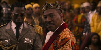 Movie still from “Coming 2 America” (2021), directed by Craig Brewer – A man wearing a crown standing in front of a group of people; Close Up shot, Low angle