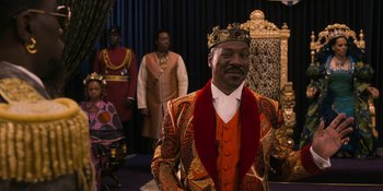 Movie still from “Coming 2 America” (2021), directed by Craig Brewer – A group of men standing next to each other in a room; Medium shot, Over the shoulder angle