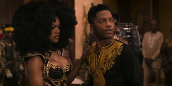 Movie still from “Coming 2 America” (2021), directed by Craig Brewer – A man and a woman are posing for a picture; Medium shot, Over the shoulder angle